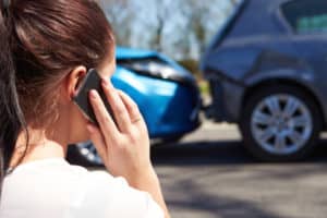 woman calling for help after a car accident