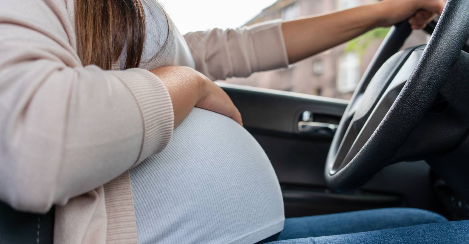 Pregnant woman driving a car