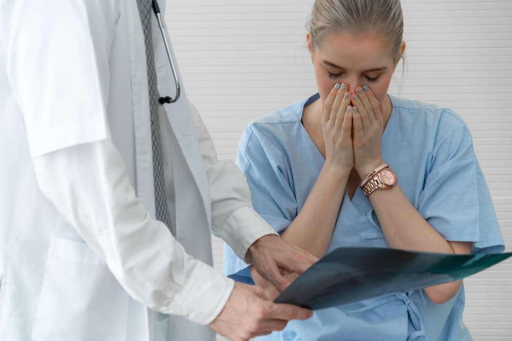 doctor confirming misdiagnosis with another medical professional